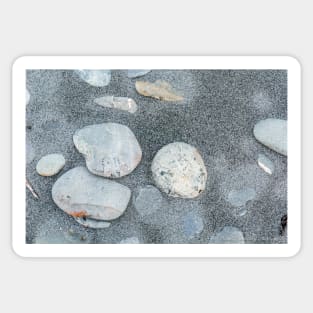 Stone scattered in sand on beach Sticker